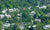 top view image of group of houses among the trees 