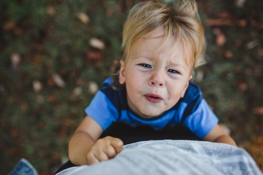 little boy crying eyes out , holding to father