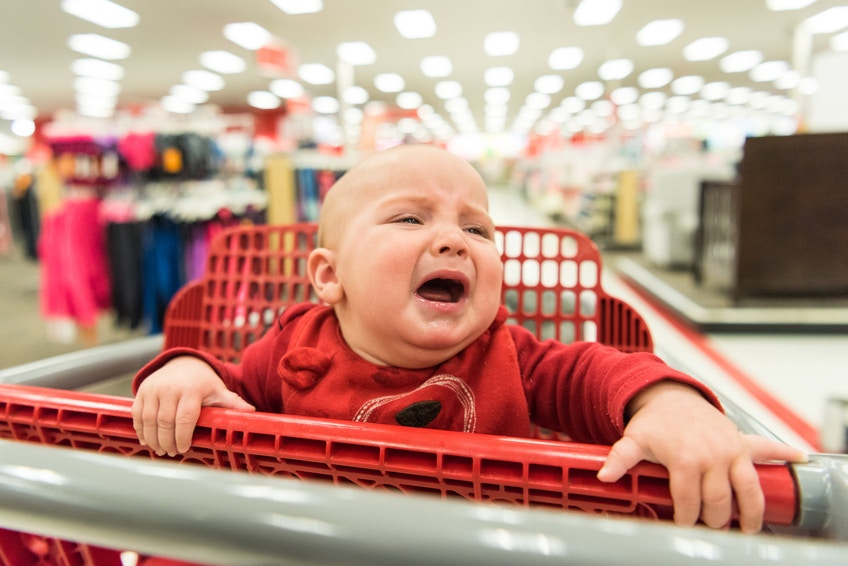 child shopping in shopping cart