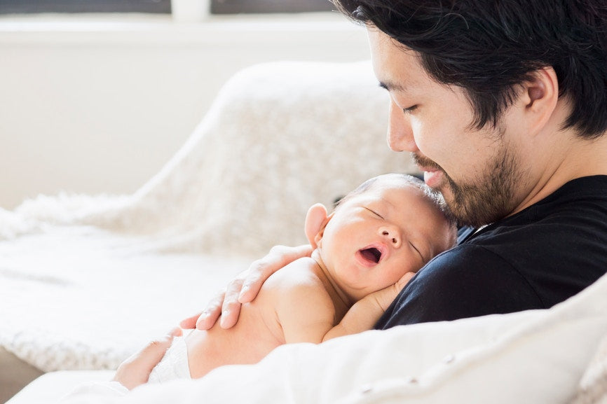 Baby Lying On Father's Chest