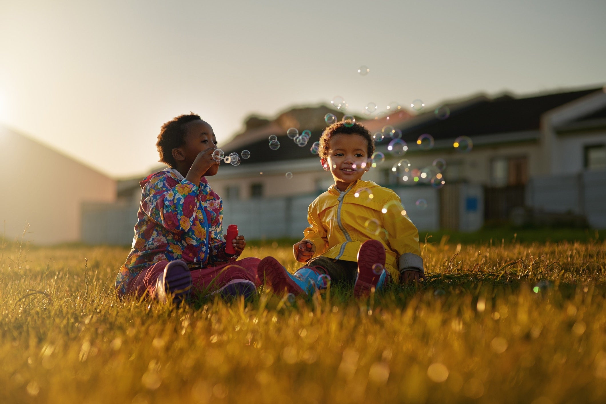 two kids playing soap bubble