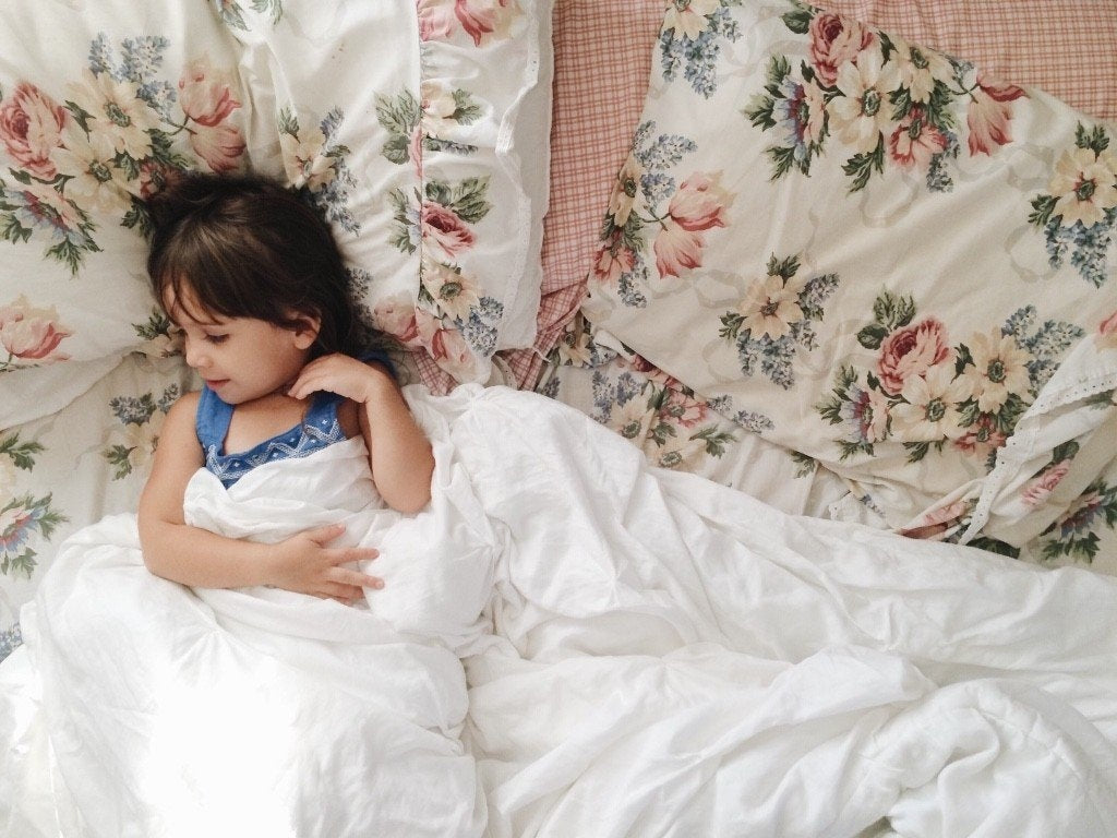 A baby girl lying in a bed