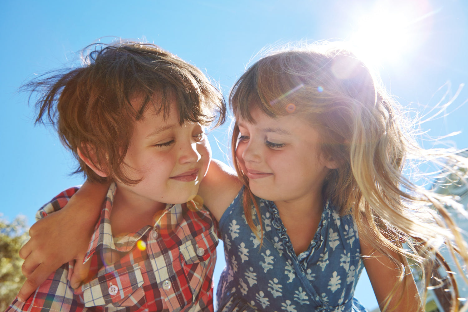 Two child friends holding each other