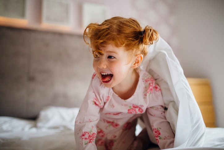 young little girl crawling on the bed.