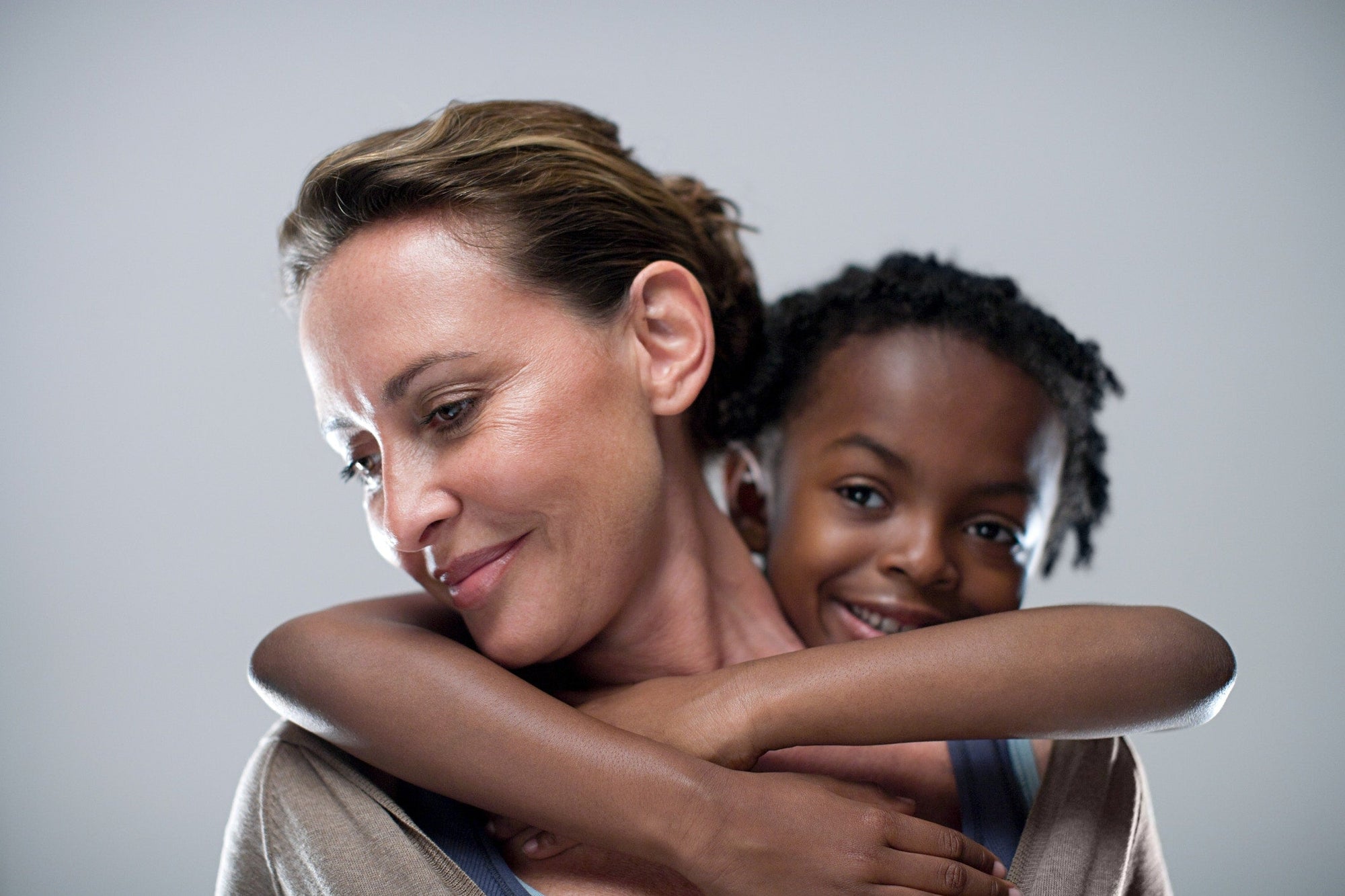 A kid is hugging its mother