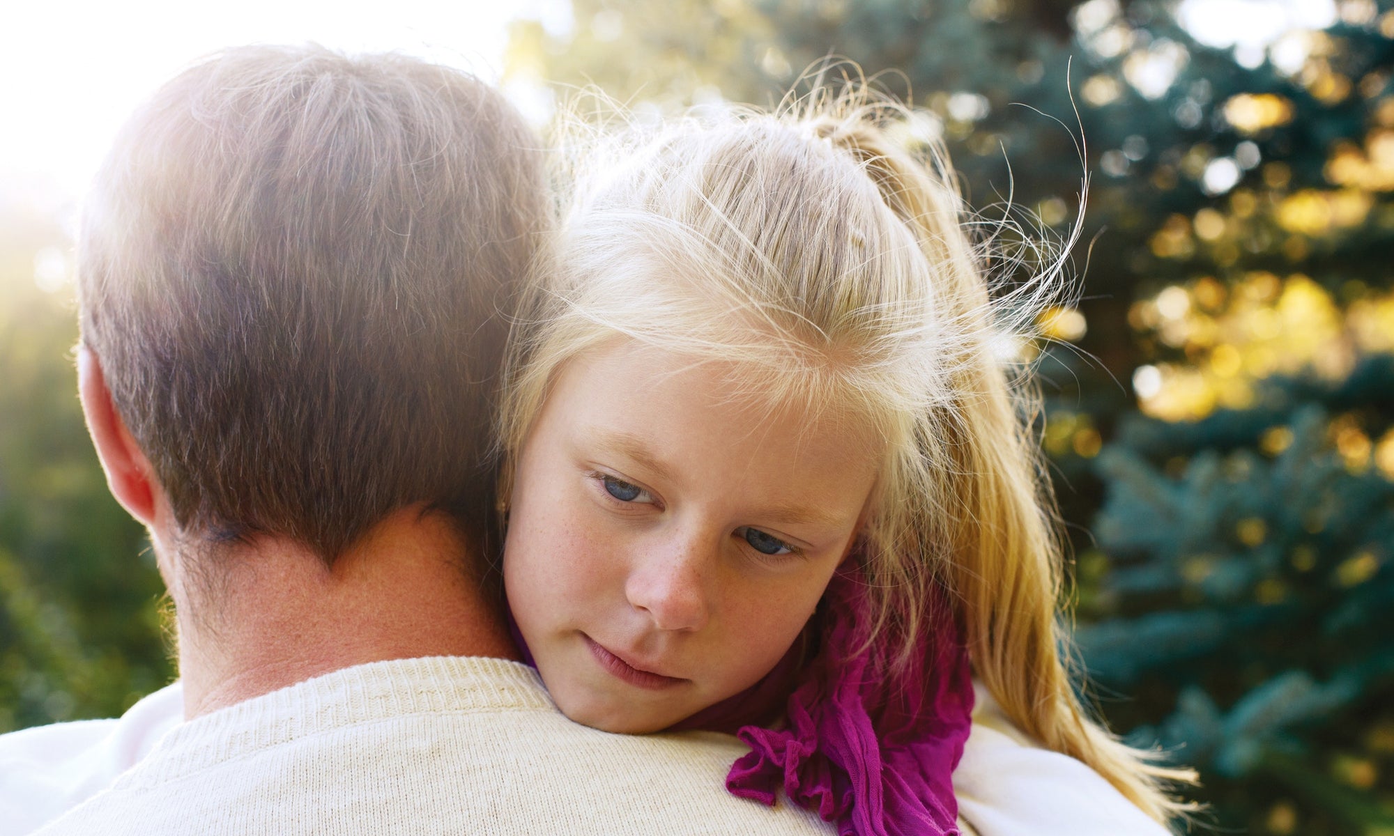 A baby hugging her father