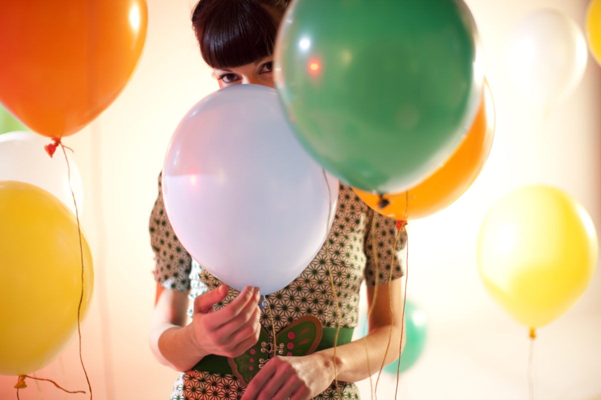 young women holding balloons