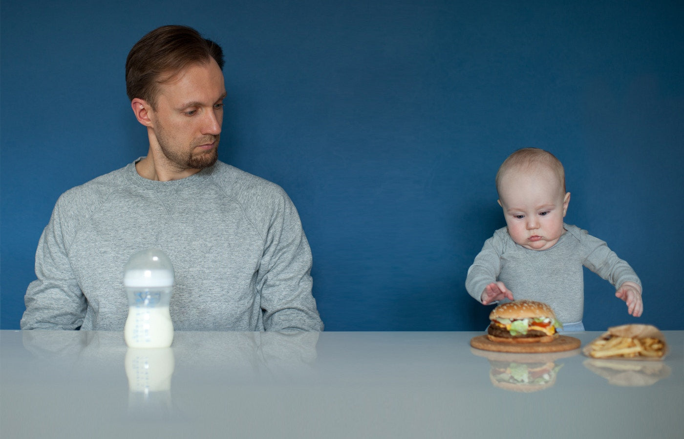 Father and child's food is exchanged,while father is stearing child food 