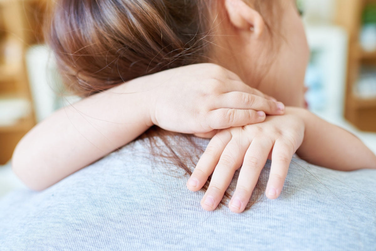 child is hugging mother