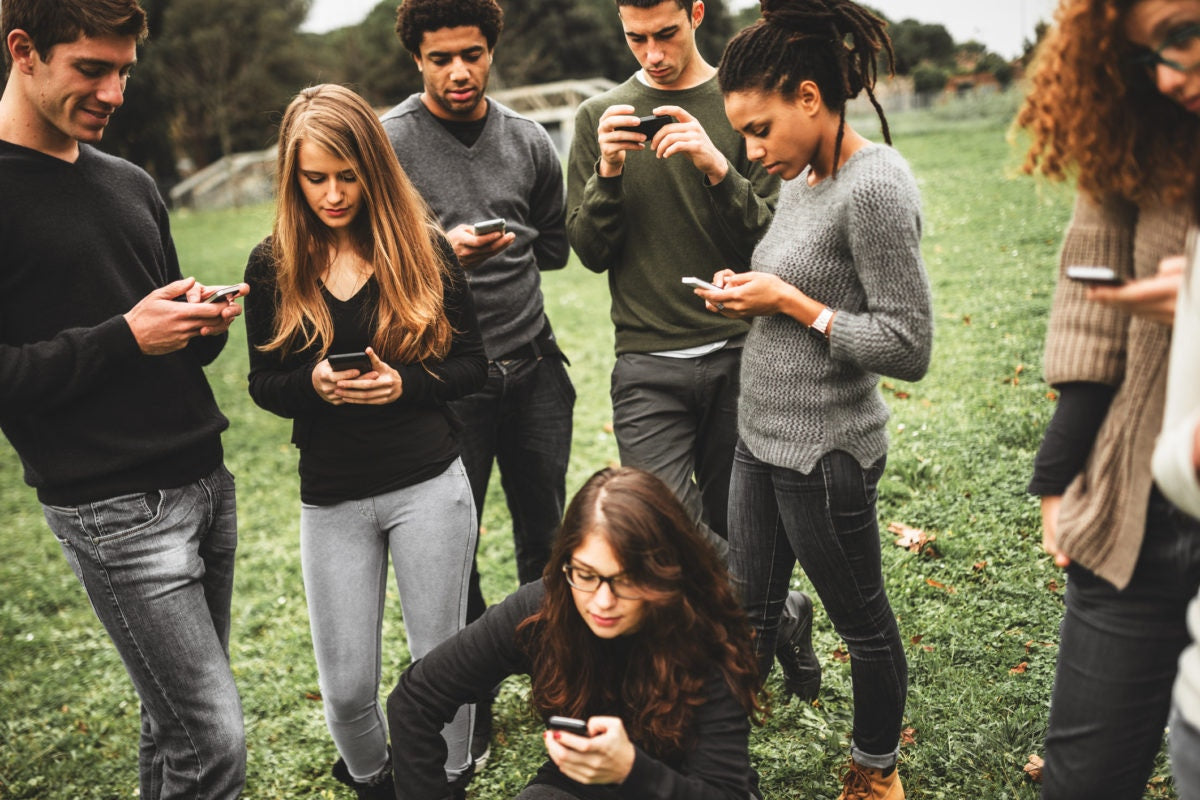 teenagers staring at their phones