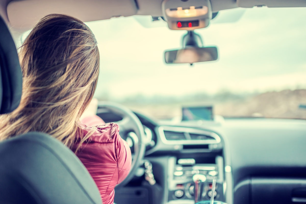 A girl is driving a car