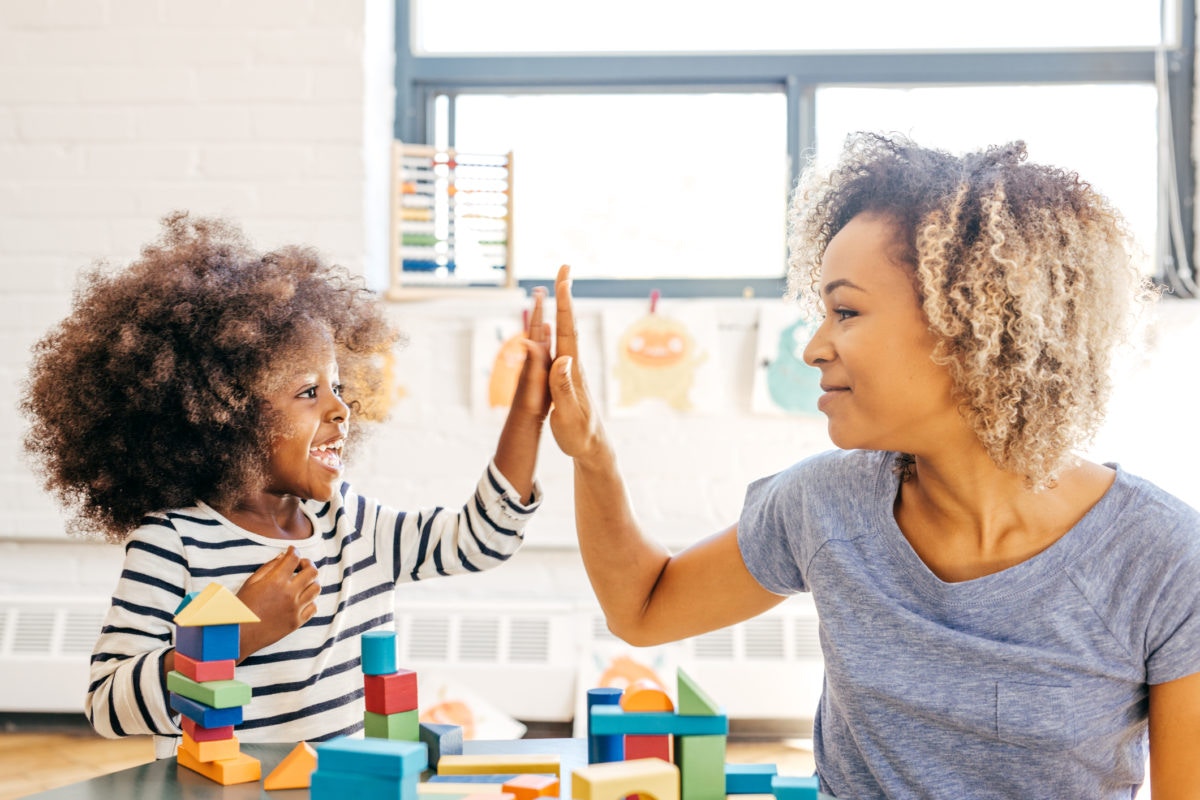 Mother And Daughter Making Hi Five Gesture