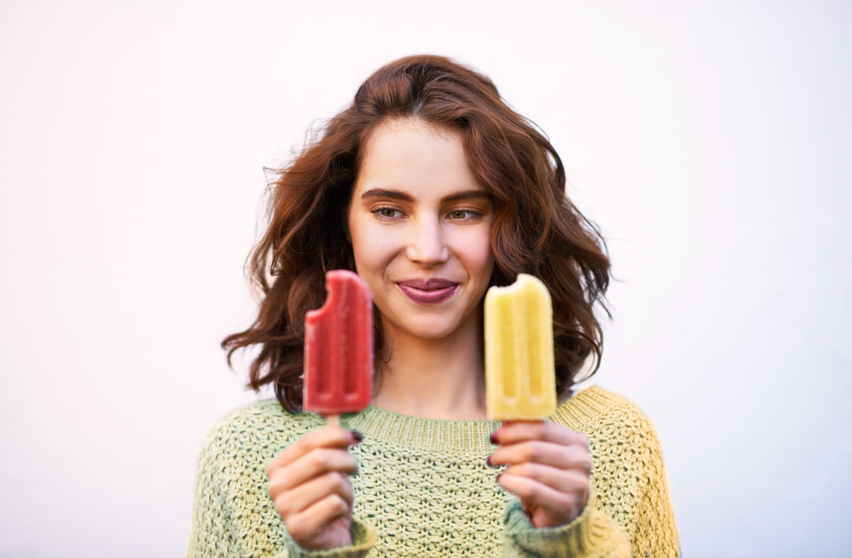 girl eating two ice cream sticks