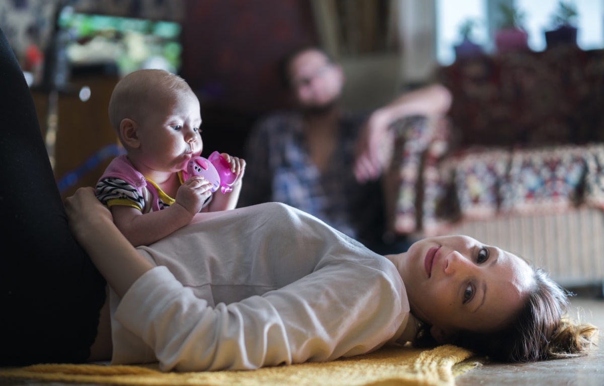 Baby is playing , while mother watching