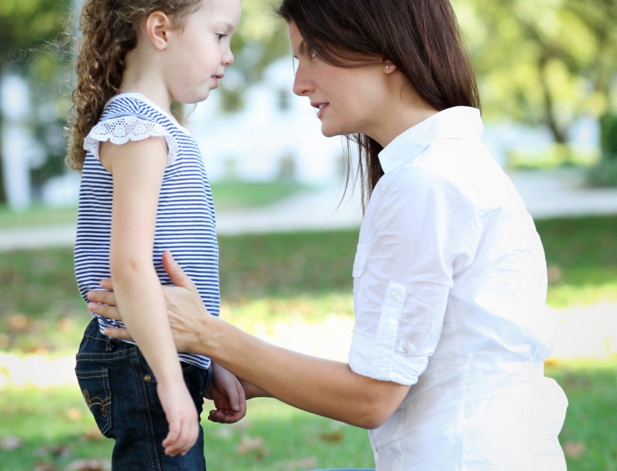 Concerned  mom and daughter talk at park