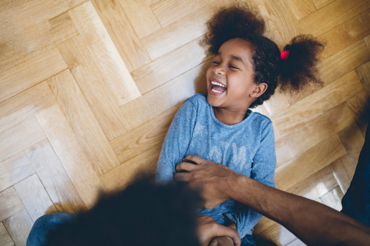 father tickling daughter