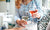 beautiful women sitting on couch holding glass of red and white wine