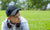 boy with headphones sitting on grass