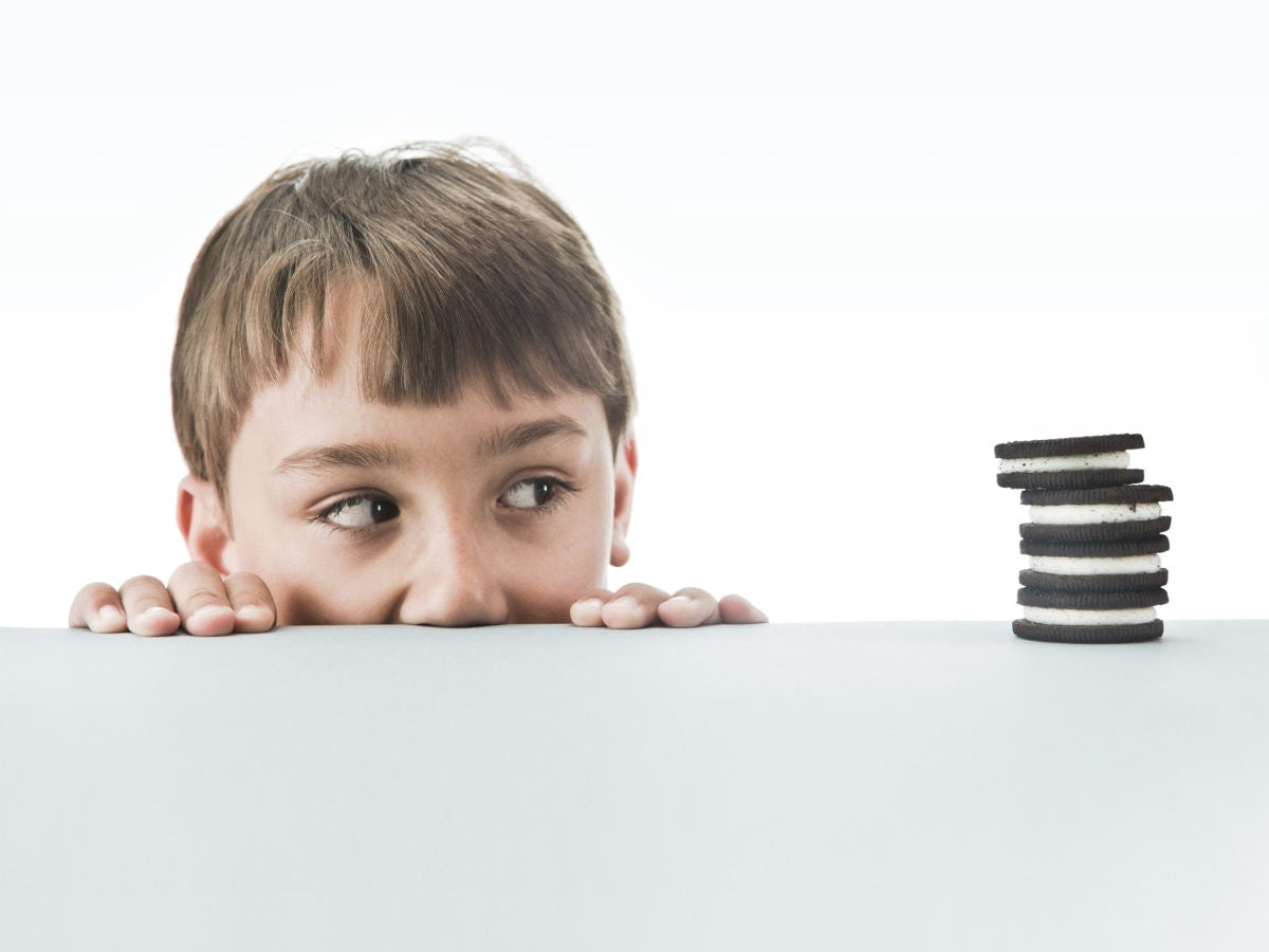 young boy looking at oreos