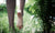  Young man walking barefoot across a grassy field