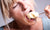 Woman eating spoon full of ice cream