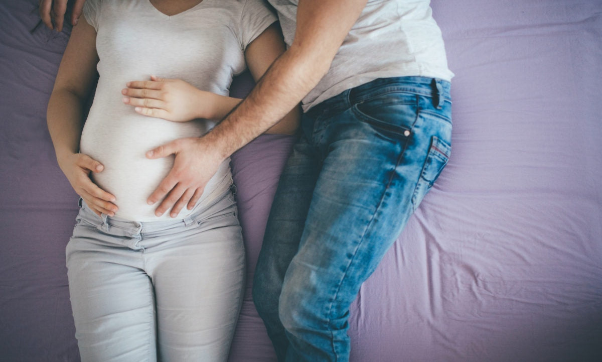 Couple feeling baby on the womb