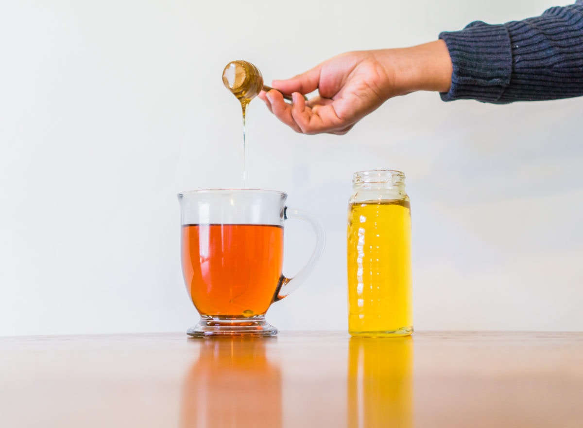 Scooping honey from jar