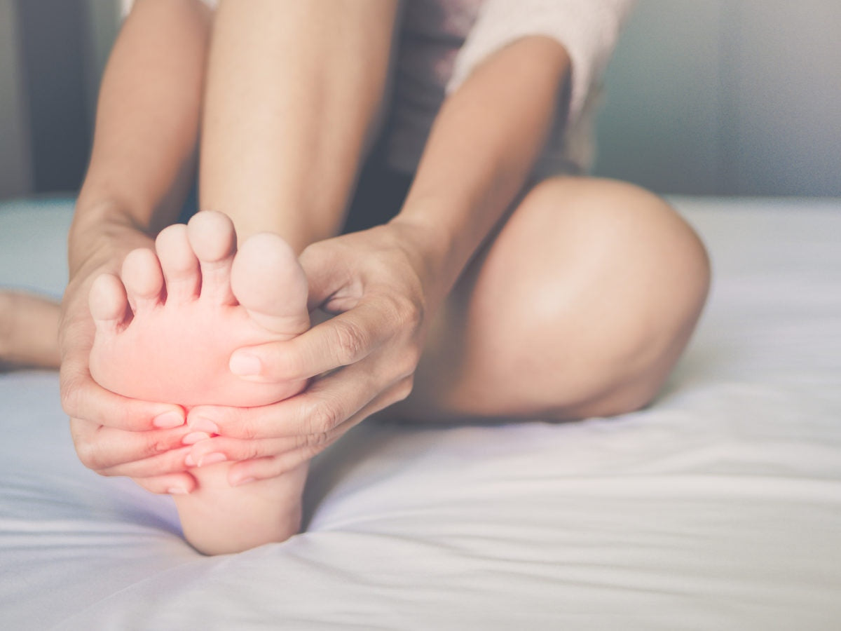 woman rubbing her feet