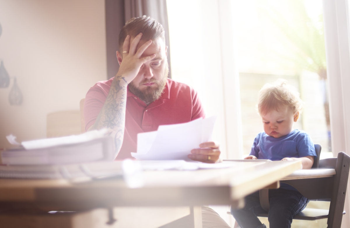 Father seeing letters while his kid is watching tab