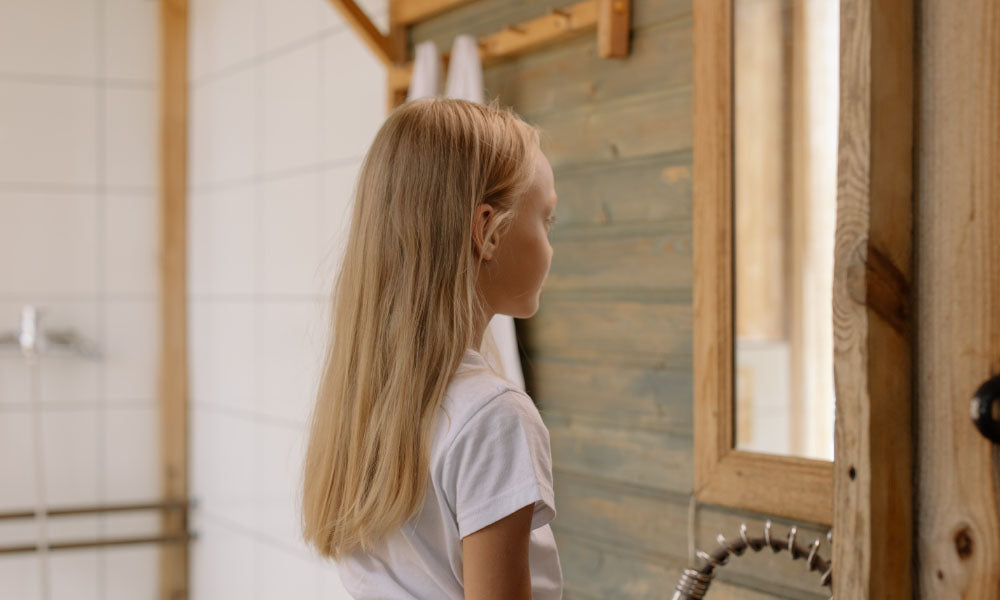 a girl Looking at a mirror