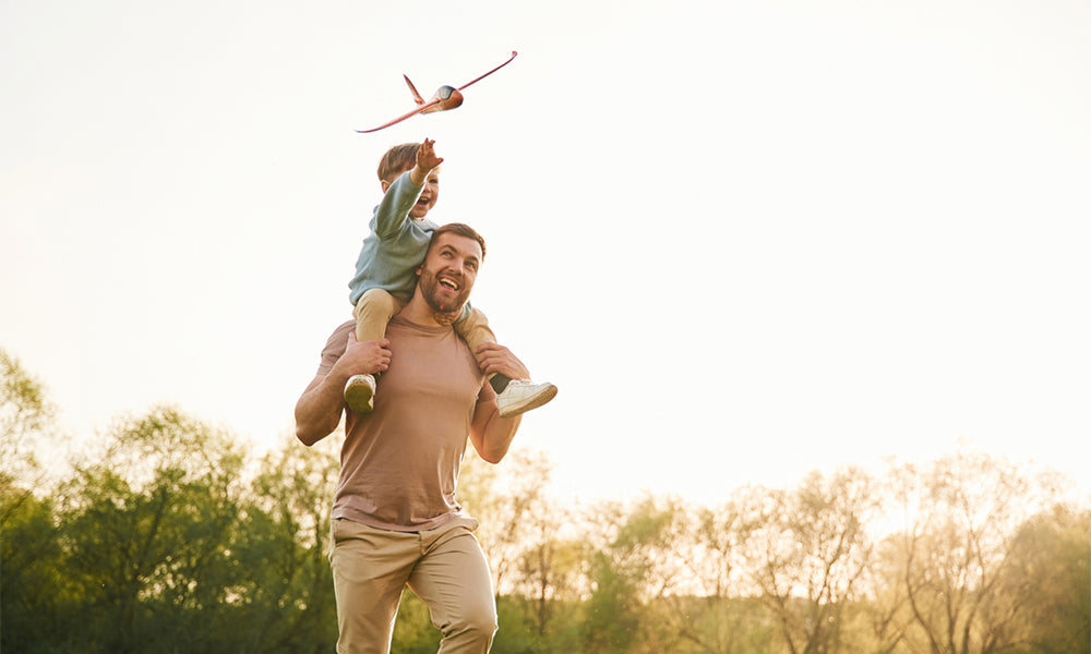 father and son playing with airplane