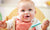 happy young baby boy in high chair