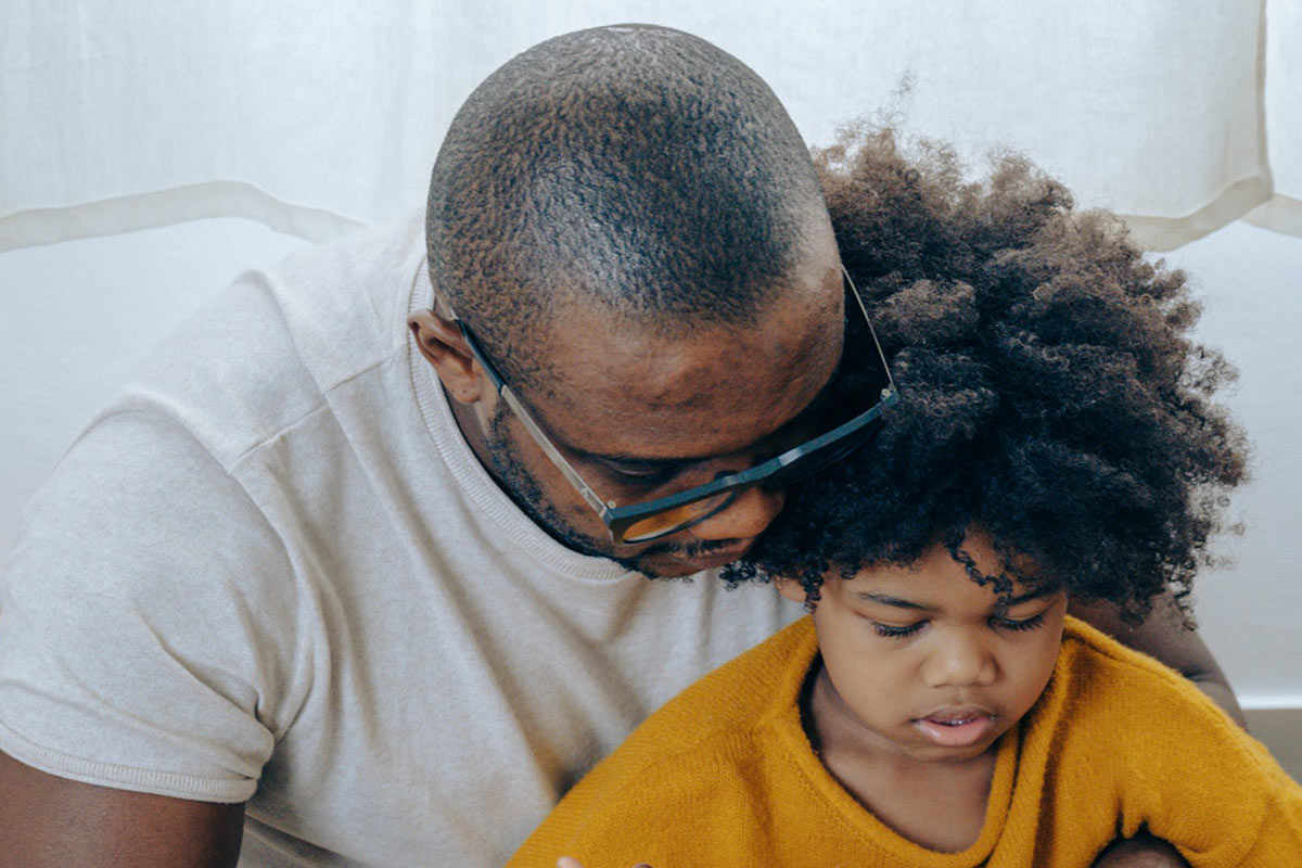 man reading to his son