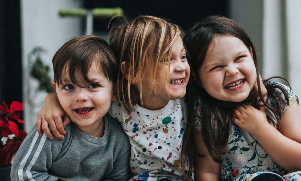 three kids smiling