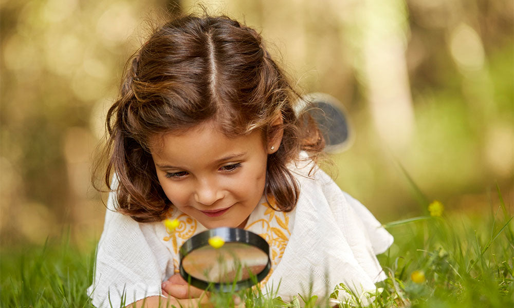 young girl looking at the grass